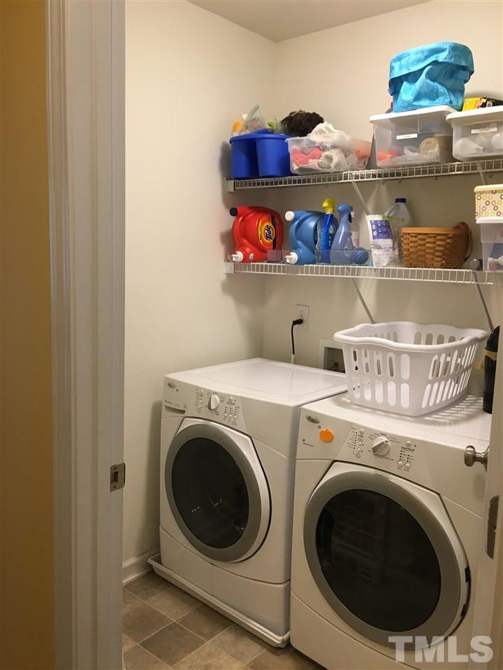 1412 Shady Rise Glen Raleigh, NC 27603 - Photo 21 of 25 Large laundry room with storage shelves.