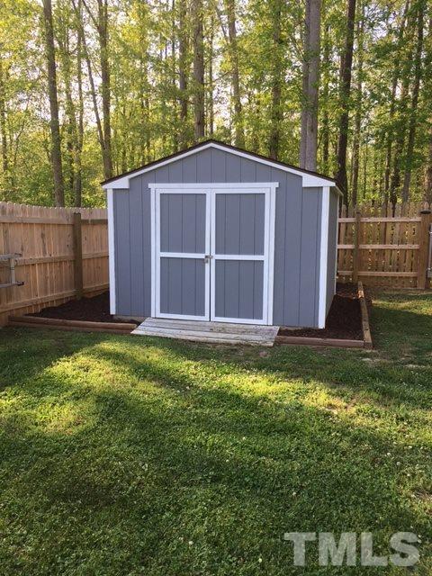 1412 Shady Rise Glen Raleigh, NC 27603 - Photo 25 of 25 Storage shed was recently painted and shelves installed on inside give extra storage space.