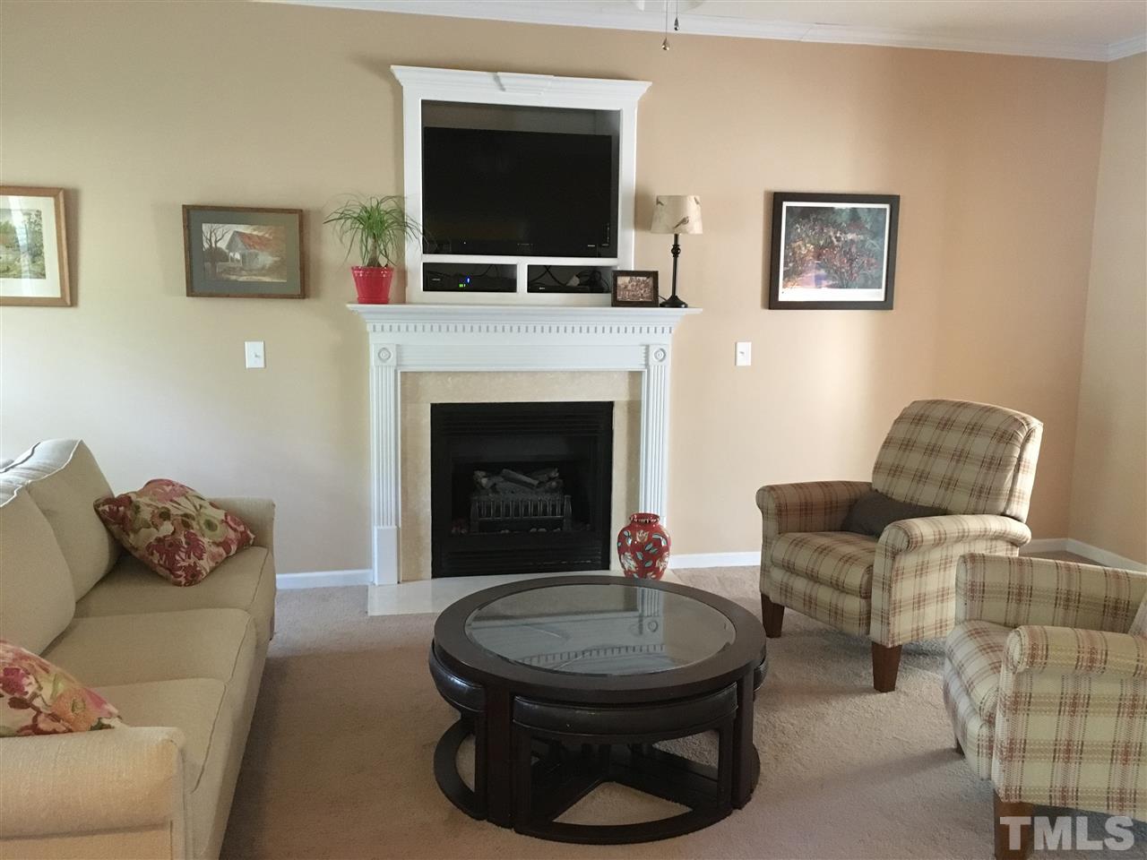 1412 Shady Rise Glen Raleigh, NC 27603 - Photo 5 of 25 Spacious living room with large windows, fireplace and ceiling fan.