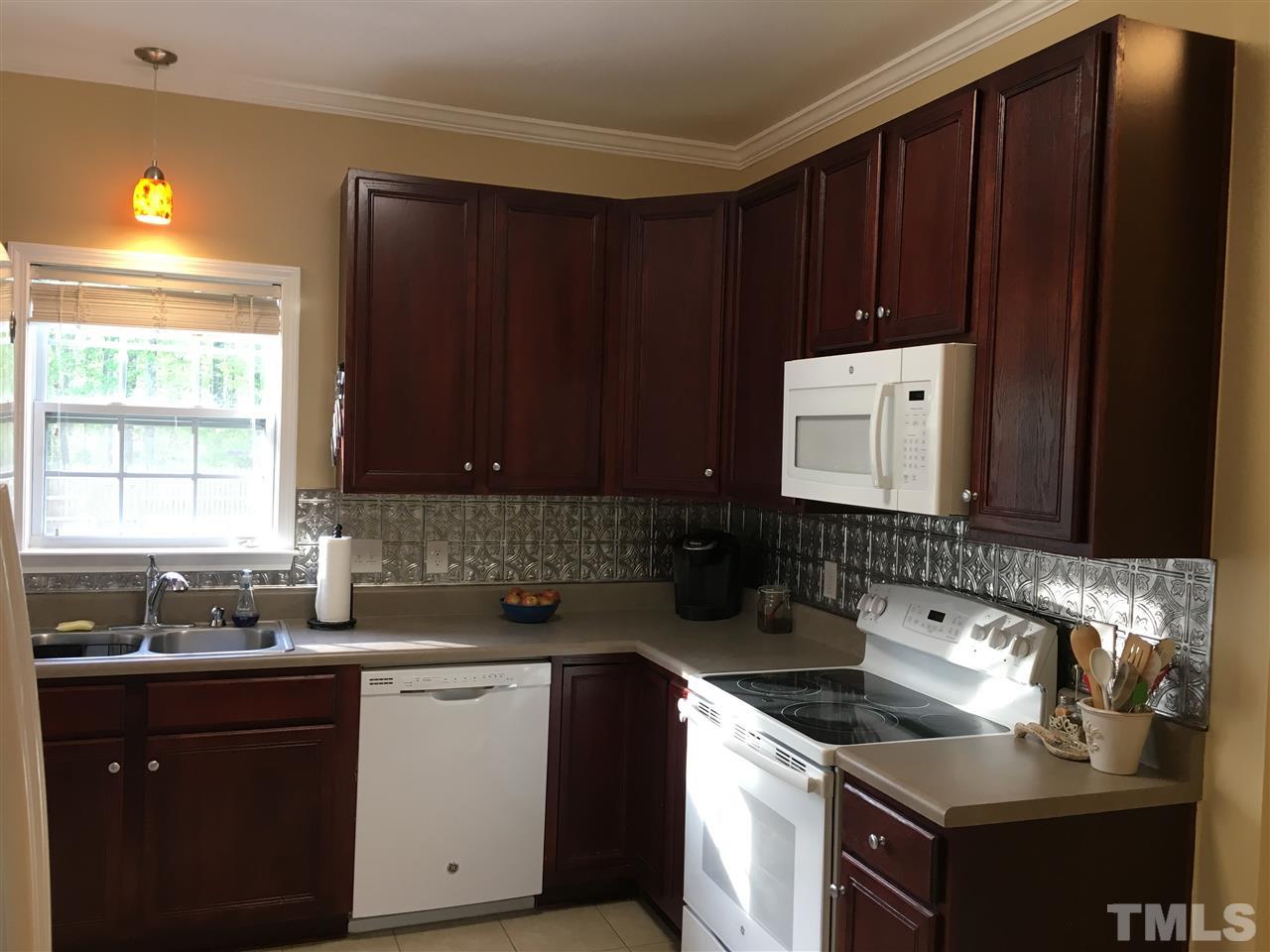 1412 Shady Rise Glen Raleigh, NC 27603 - Photo 8 of 25 Recently updated kitchen with new appliances, new back splash, new tile flooring, and under-counter lighting.