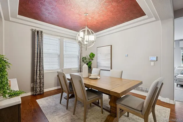 a view of a dining room with furniture and chandelier