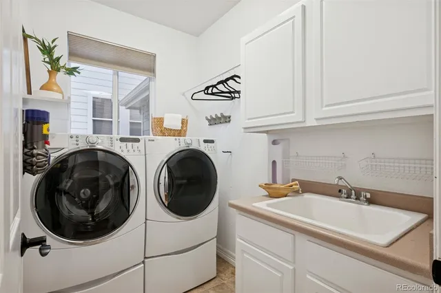 a utility room with sink dryer and washer