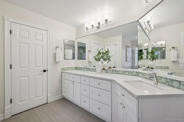 a spacious bathroom with a granite countertop sink a mirror and a