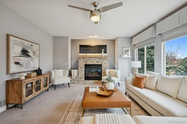 a living room with furniture fireplace and window
