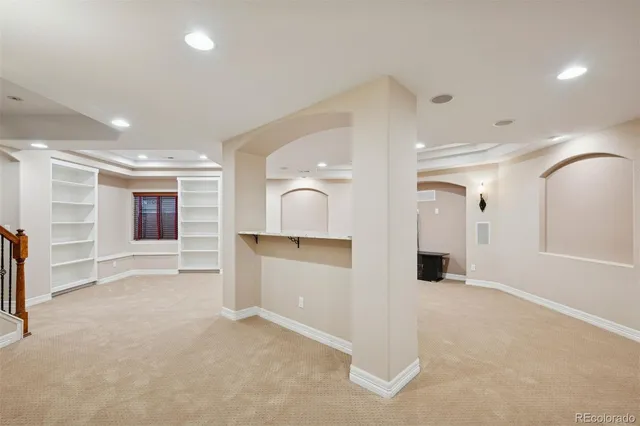 a room with walk in closet and a refrigerator