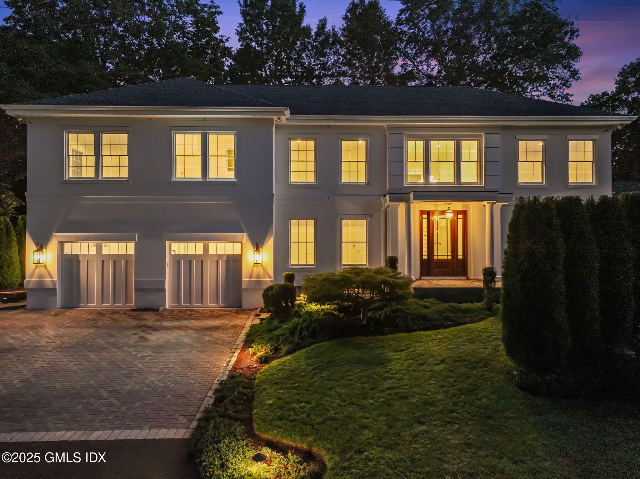 22 Carleton Street Greenwich, CT 06830 - Photo 24 of 26 a front view of house with yard and trees in the background