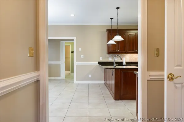 a kitchen with stainless steel appliances granite countertop a sink a stove and a refrigerator