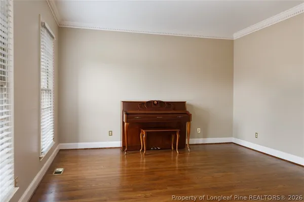 a view of an empty room with wooden floor