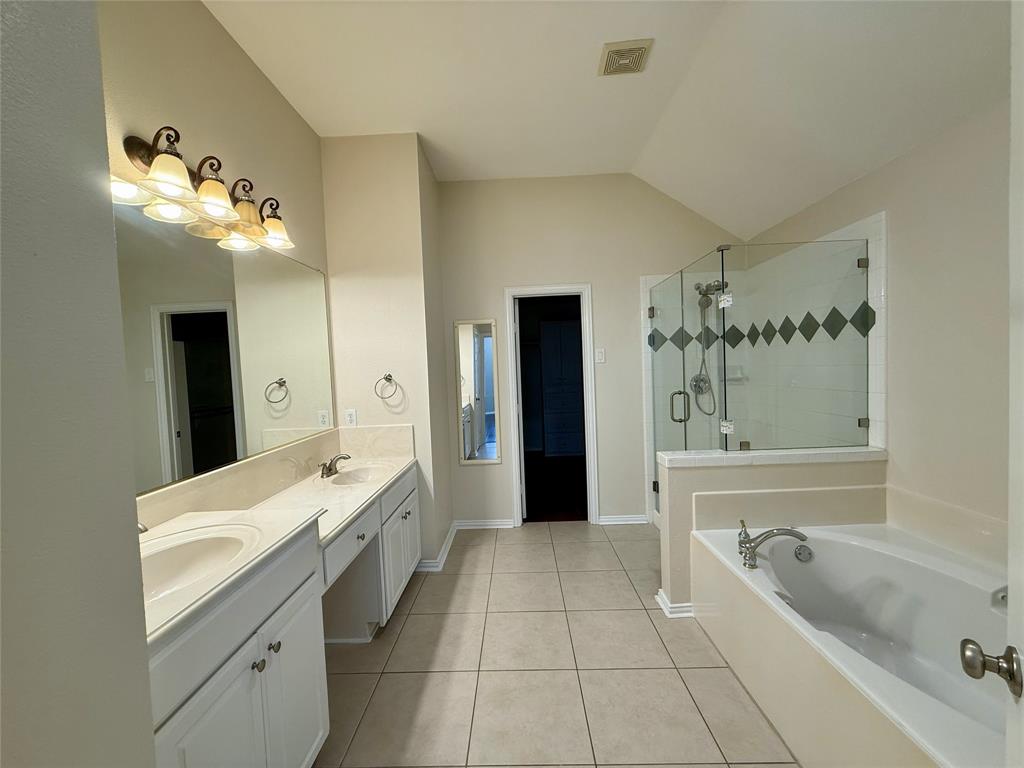 131 Fallkirk Drive Coppell, TX 75019 - Photo 17 of 20 a spacious bathroom with a tub sink and mirror