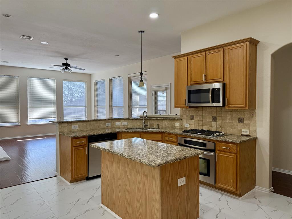 131 Fallkirk Drive Coppell, TX 75019 - Photo 4 of 20 a kitchen with granite countertop a sink and a stove top oven