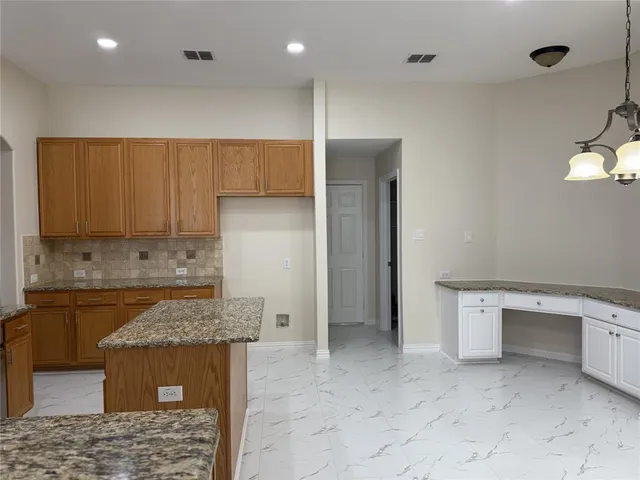 a kitchen with a sink cabinets and wooden floor