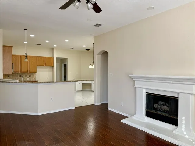 a view of a kitchen with a sink and a fireplace