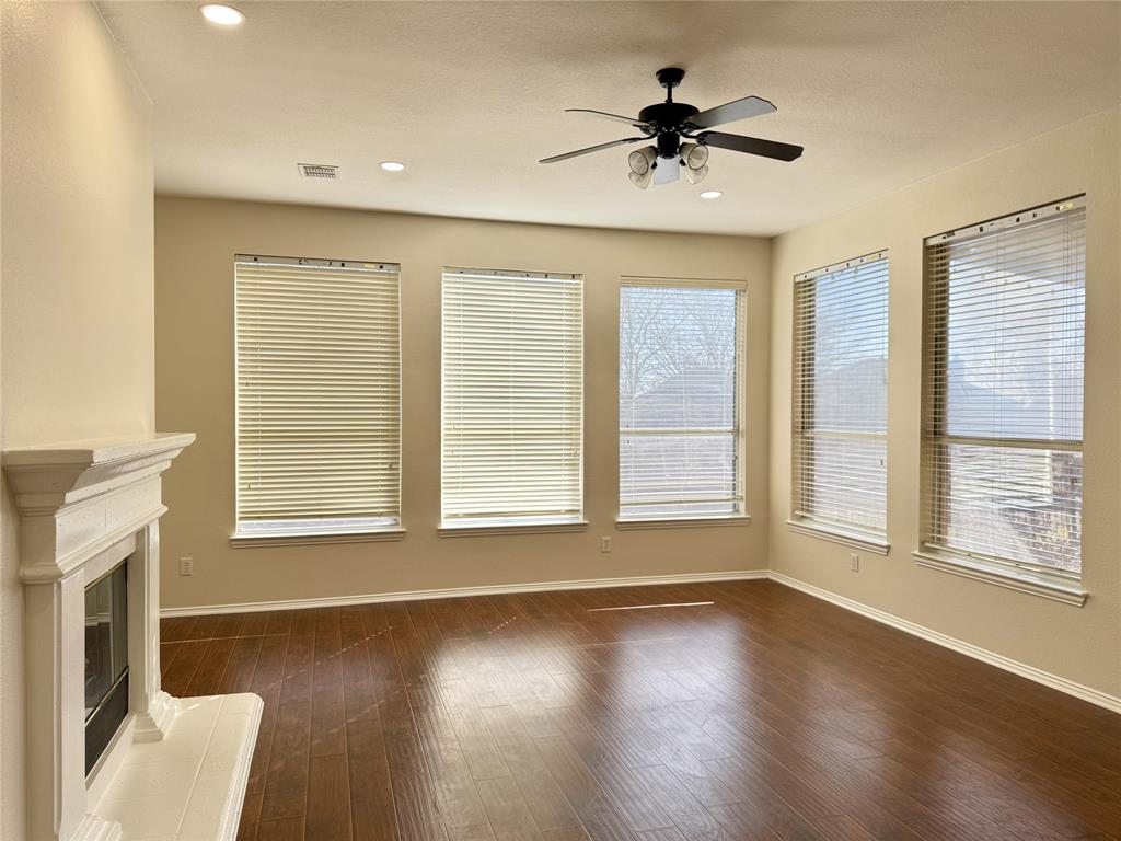 131 Fallkirk Drive Coppell, TX 75019 - Photo 8 of 20 a view of wooden floor and a chandelier fan in a room