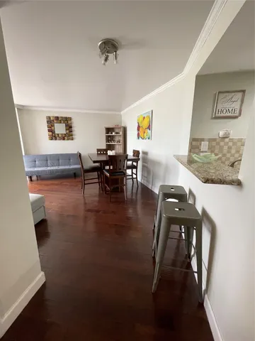 a view of a dining room with furniture and wooden floor