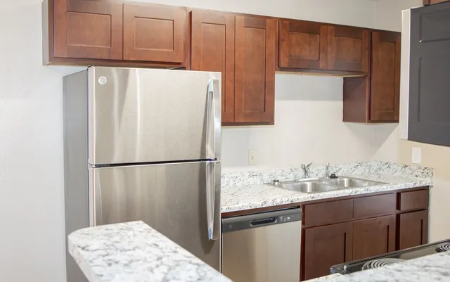 a white refrigerator freezer sitting inside of a kitchen
