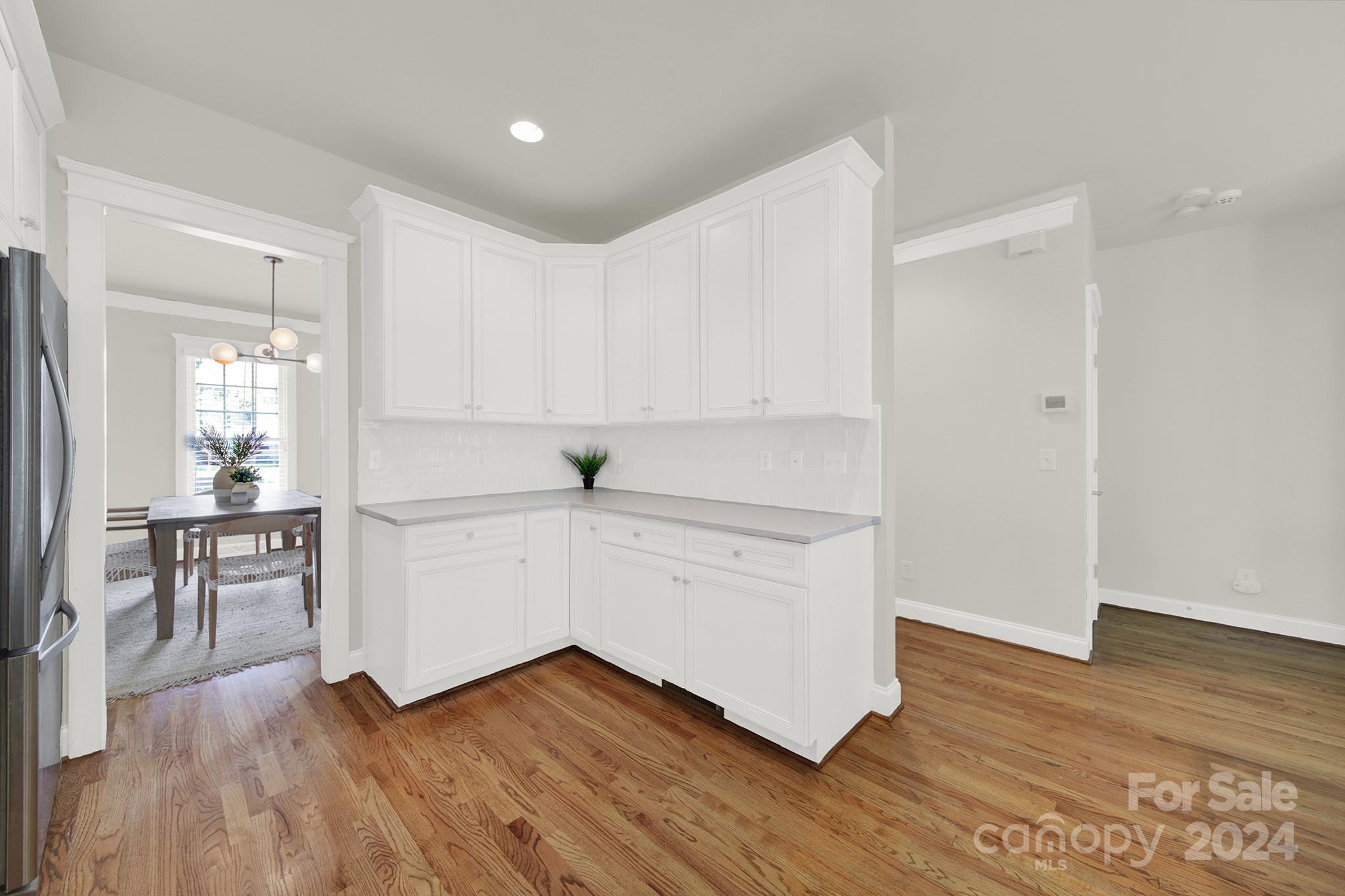 130 Mills Lane Fort Mill, SC 29708 - Photo 12 of 48 a kitchen with wooden floors and white appliances