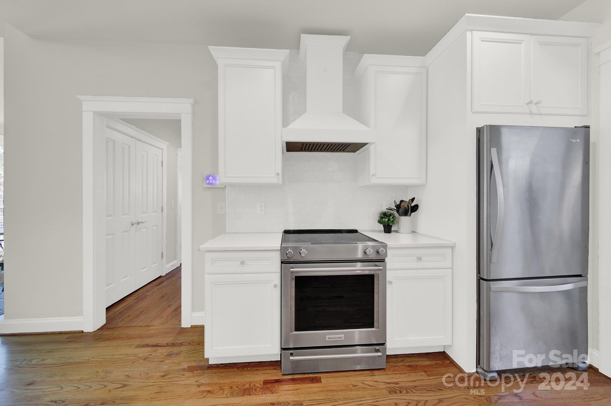 130 Mills Lane Fort Mill, SC 29708 - Photo 13 of 48 a kitchen with stainless steel appliances a refrigerator stove and cabinets