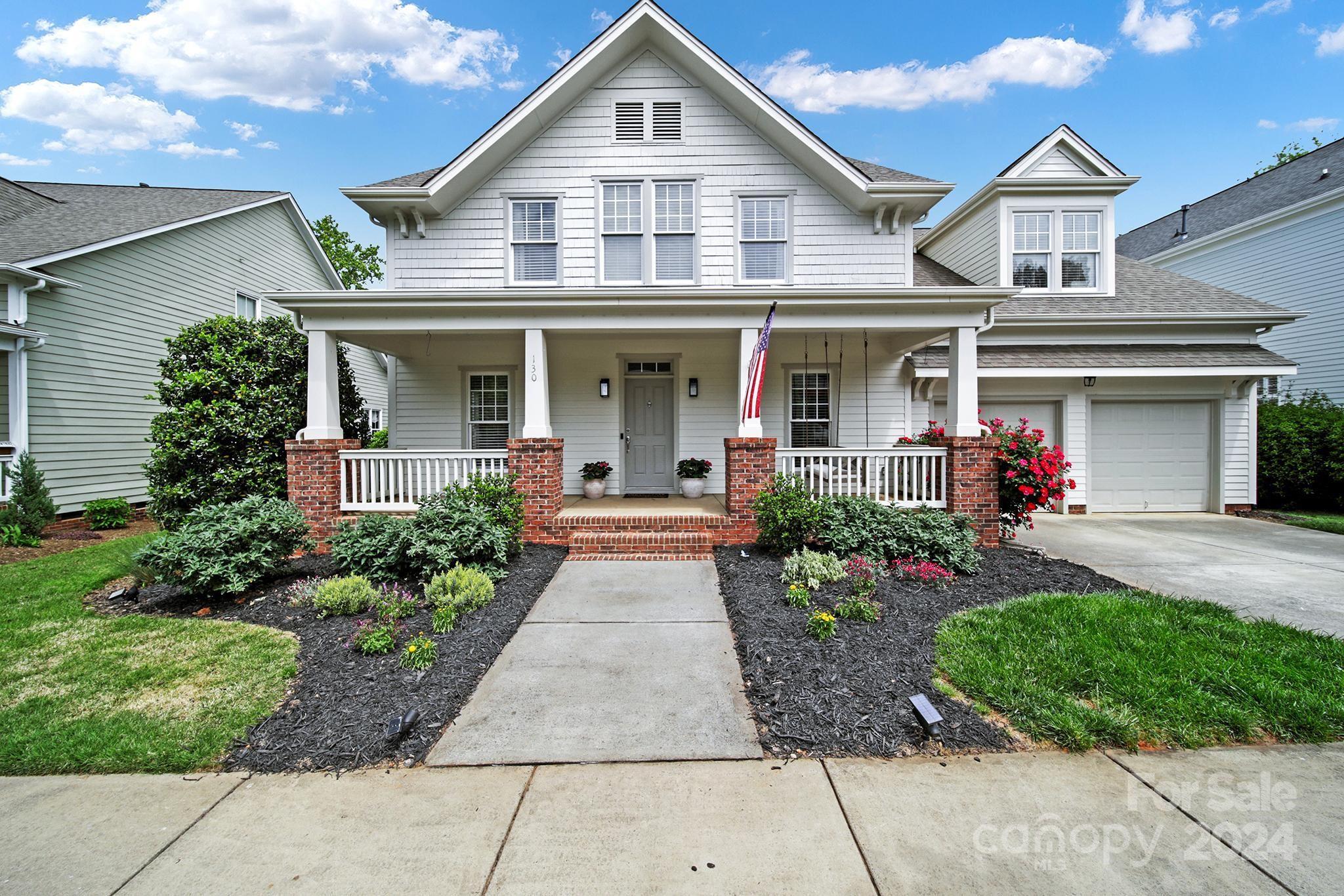 130 Mills Lane Fort Mill, SC 29708 - Photo 2 of 48 a front view of a house with garden
