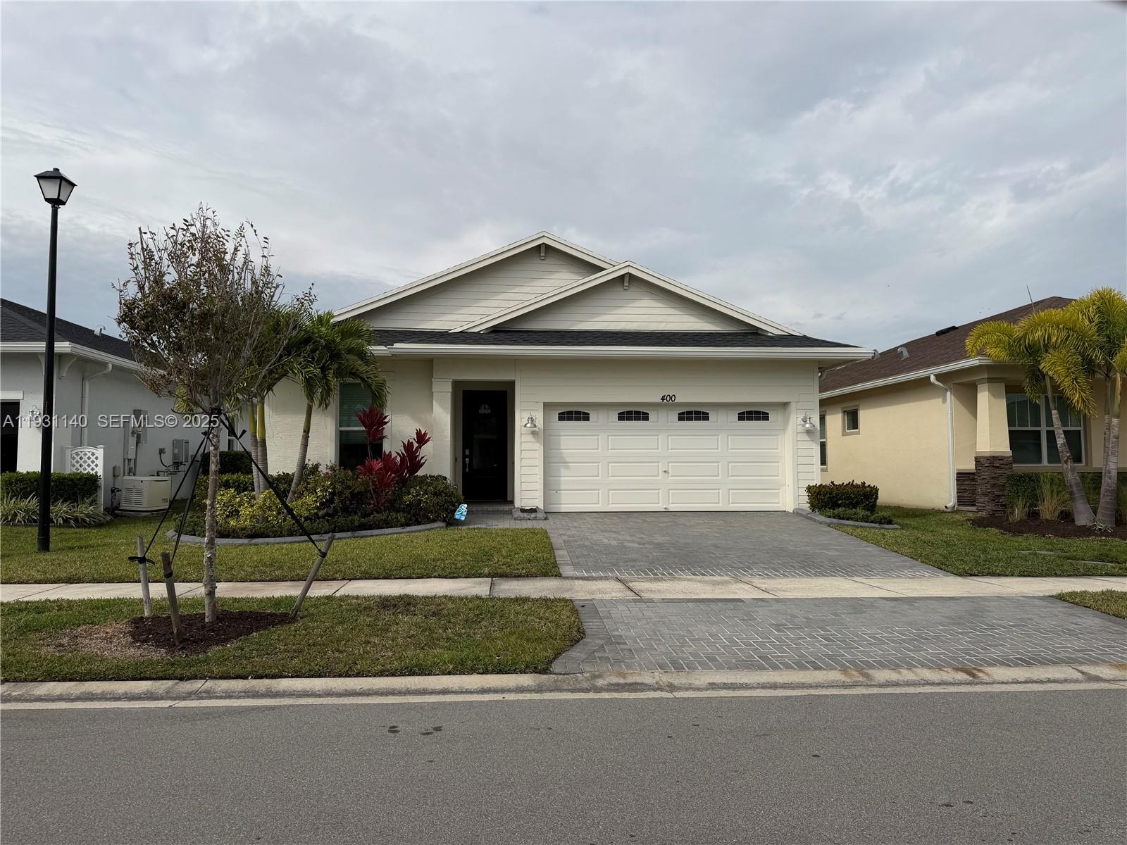 a front view of a house with a yard and garage