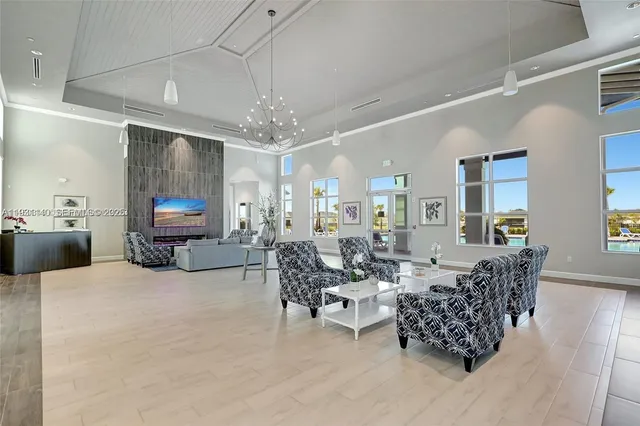 a living room with furniture and a chandelier