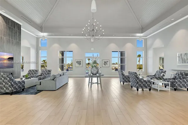 a living room with furniture or chandelier and a wooden floor