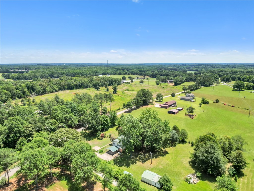 602 Harper Road Pendleton, SC 29670 - Photo 31 of 32 Vast green acreage provides an idyllic rural setting with multiple structures nestled among mature trees.