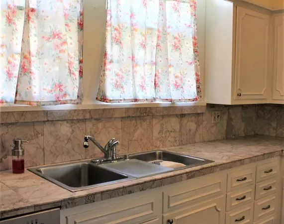a kitchen with granite countertop a sink and granite counter tops