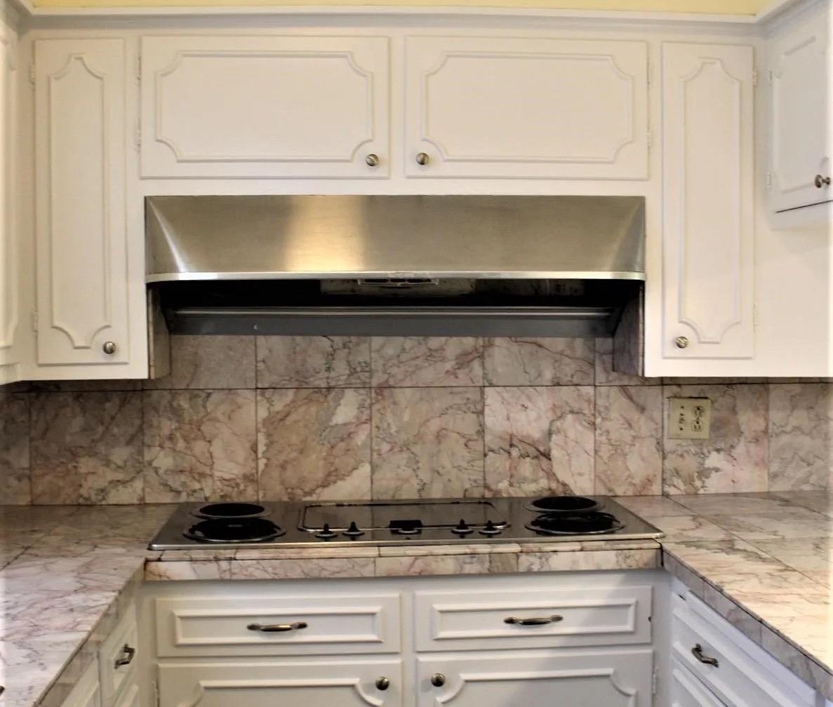 230 Lake Drive Ripley, TN 38063 - Photo 5 of 24 a stove top oven sitting inside of a kitchen
