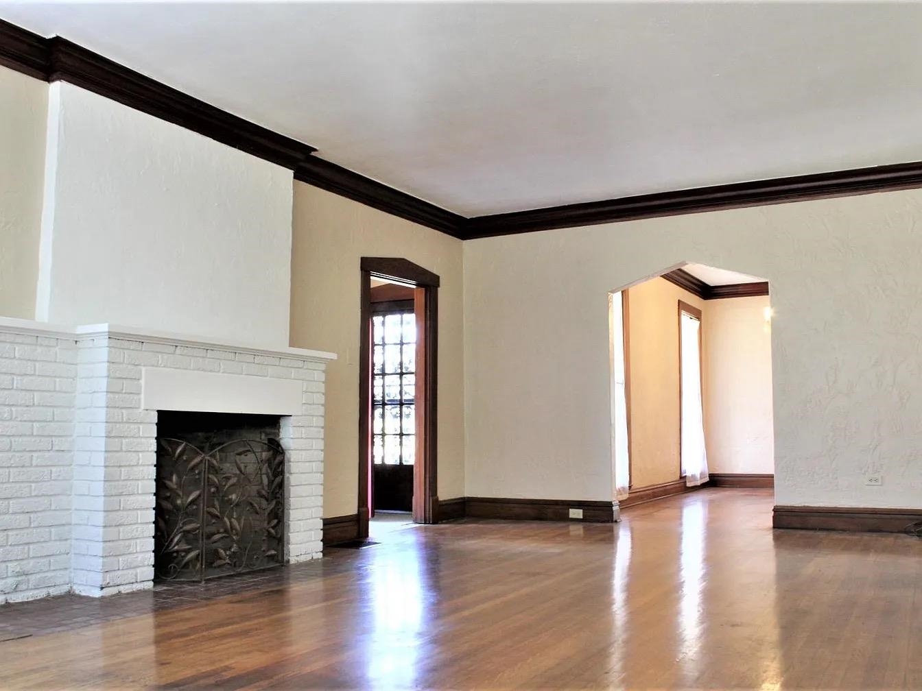 230 Lake Drive Ripley, TN 38063 - Photo 7 of 24 a view of an empty room with wooden floor and a fireplace