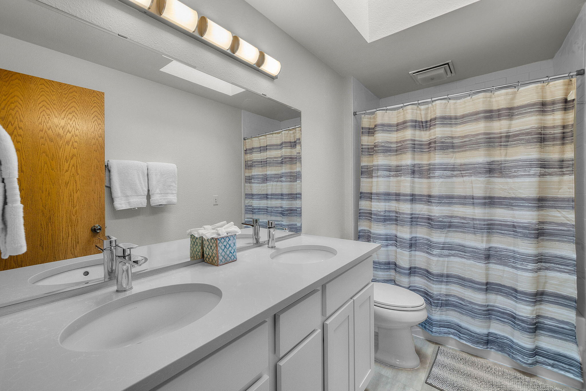 13168 Hawks Beard Black Butte Ranch, OR 97759 - Photo 30 of 47 a bathroom with a double vanity sink toilet and shower