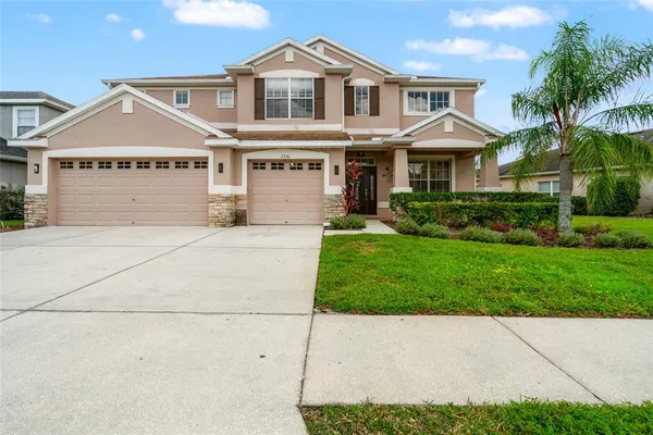 a front view of a house with a yard and garage