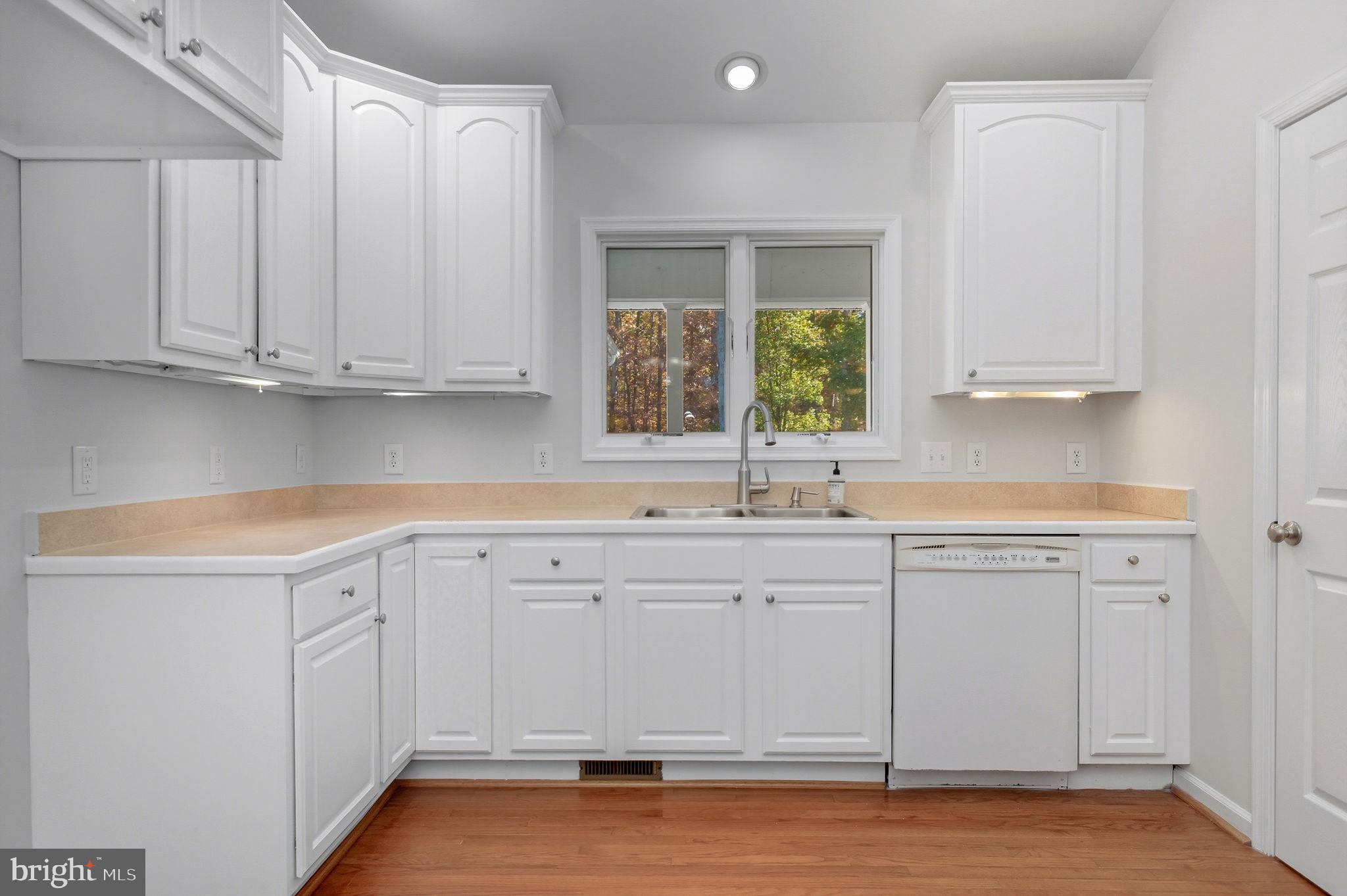1923 Hensley Road Mineral, VA 23117 - Photo 11 of 62 a kitchen with white cabinets and sink