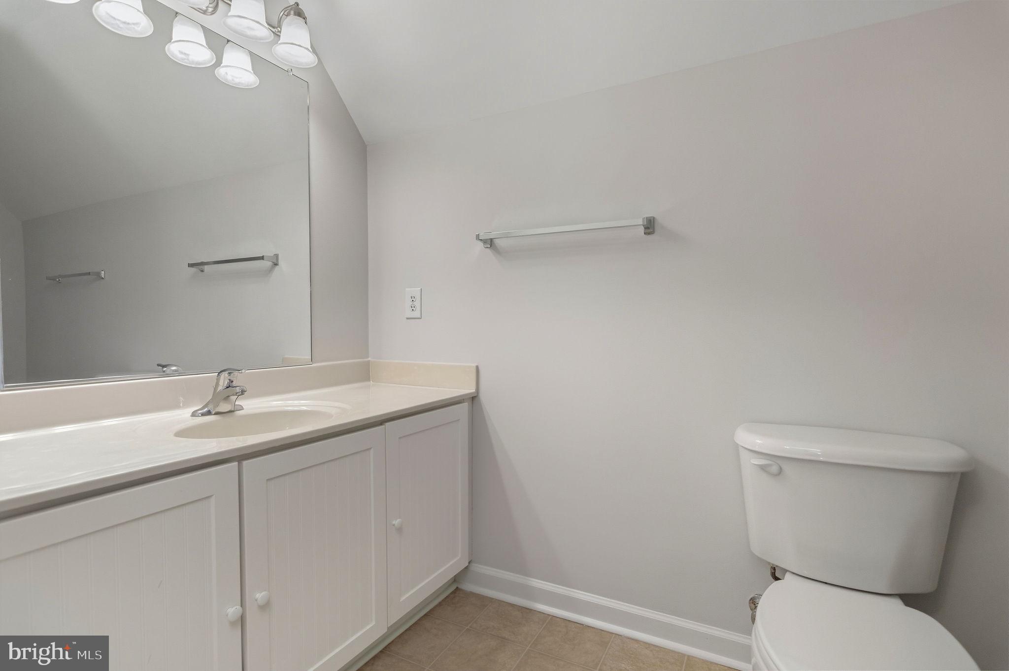 1923 Hensley Road Mineral, VA 23117 - Photo 24 of 62 a bathroom with a granite countertop toilet sink and mirror