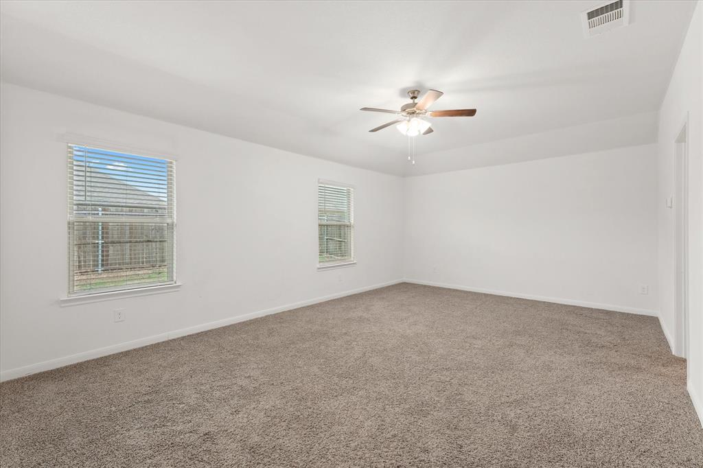 605 Spur Ridge Princeton, TX 75407 - Photo 12 of 30 an empty room with windows and fan