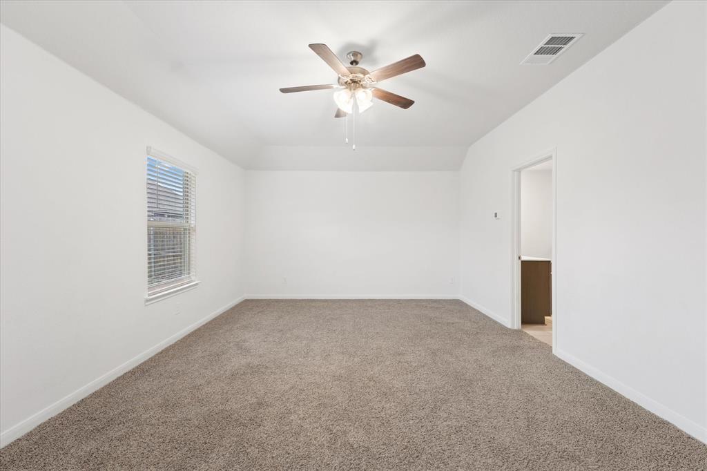 605 Spur Ridge Princeton, TX 75407 - Photo 13 of 30 an empty room with ceiling fan and window