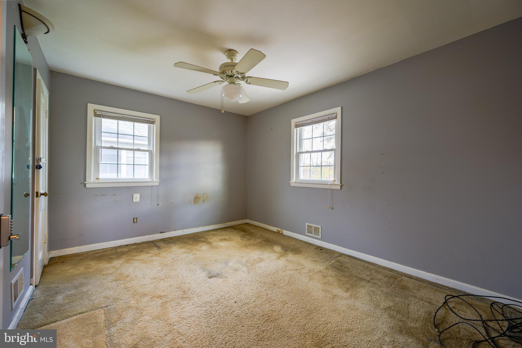 1518 Gridley Lane Silver Spring, MD 20902 - Photo 5 of 7 an empty room with windows and fan
