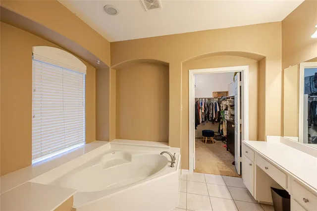a spacious bathroom with a tub and shower
