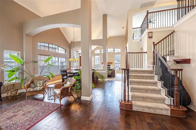 a view of a livingroom with wooden floor and furniture