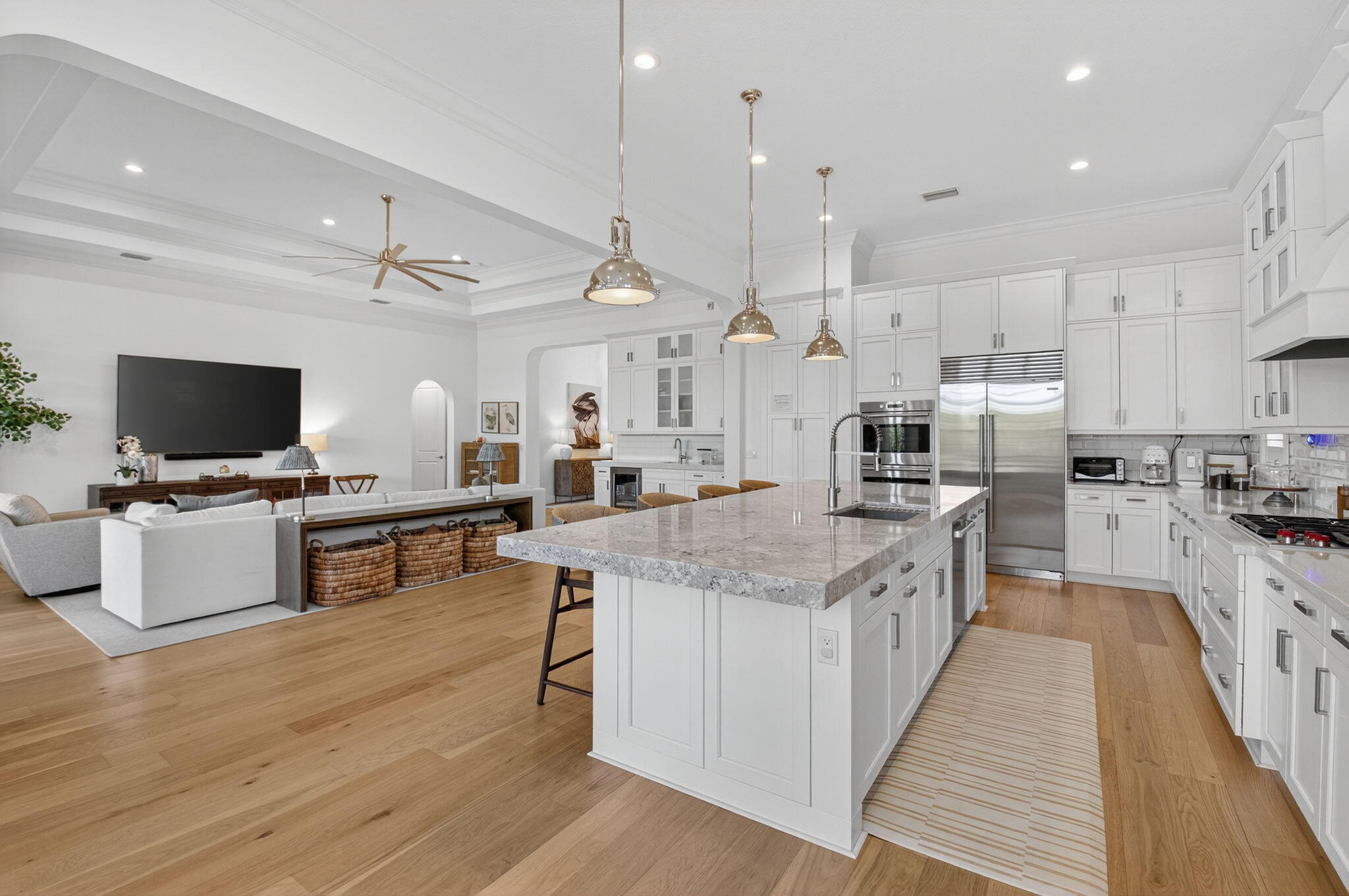 9331 Grand Prix Lane Boynton Beach, FL 33472 - Photo 12 of 96 a large kitchen with stainless steel appliances kitchen island granite countertop a stove and a view of living room