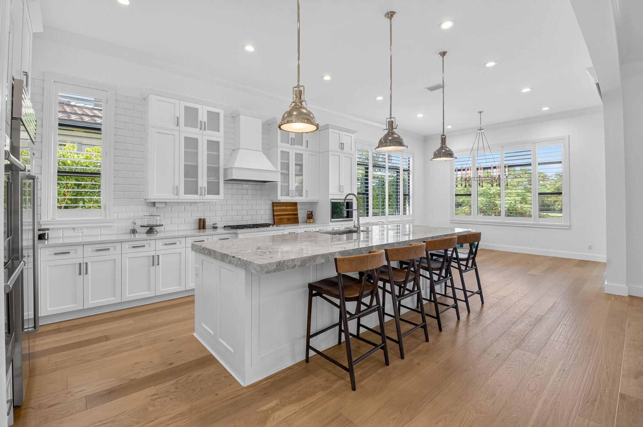 9331 Grand Prix Lane Boynton Beach, FL 33472 - Photo 18 of 96 a kitchen with stainless steel appliances granite countertop wooden floors stove sink and cabinets