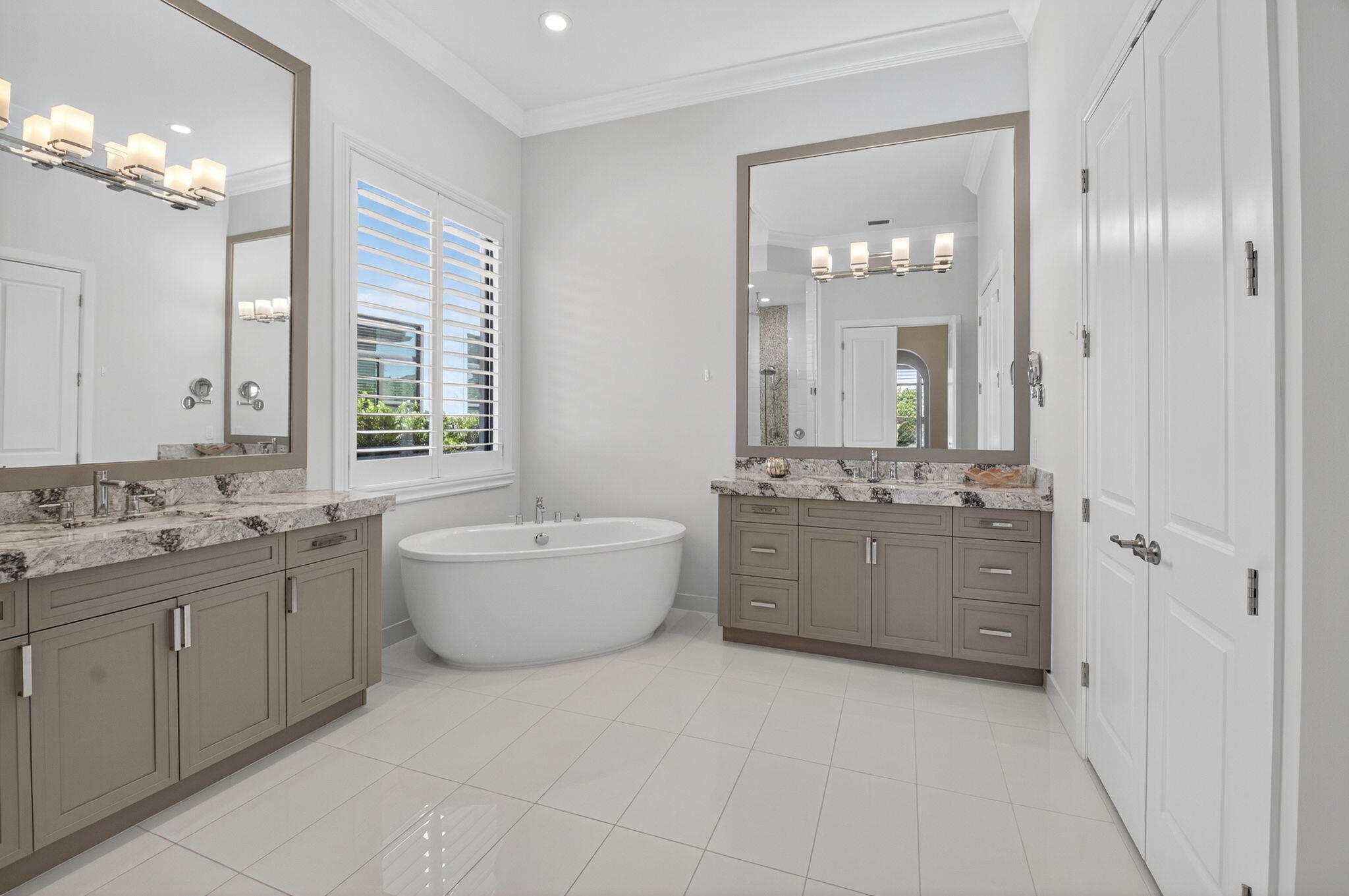 9331 Grand Prix Lane Boynton Beach, FL 33472 - Photo 26 of 96 a bathroom with a granite countertop double vanity sink a large mirror a bathtub and window