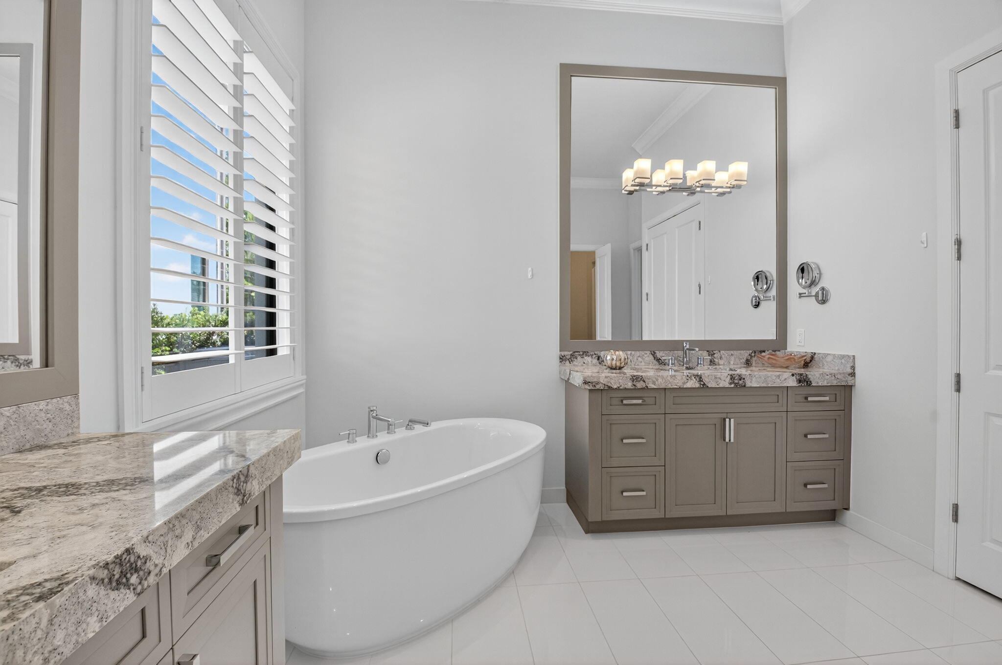 9331 Grand Prix Lane Boynton Beach, FL 33472 - Photo 30 of 96 a bathroom with a granite countertop bathtub a sink and a window