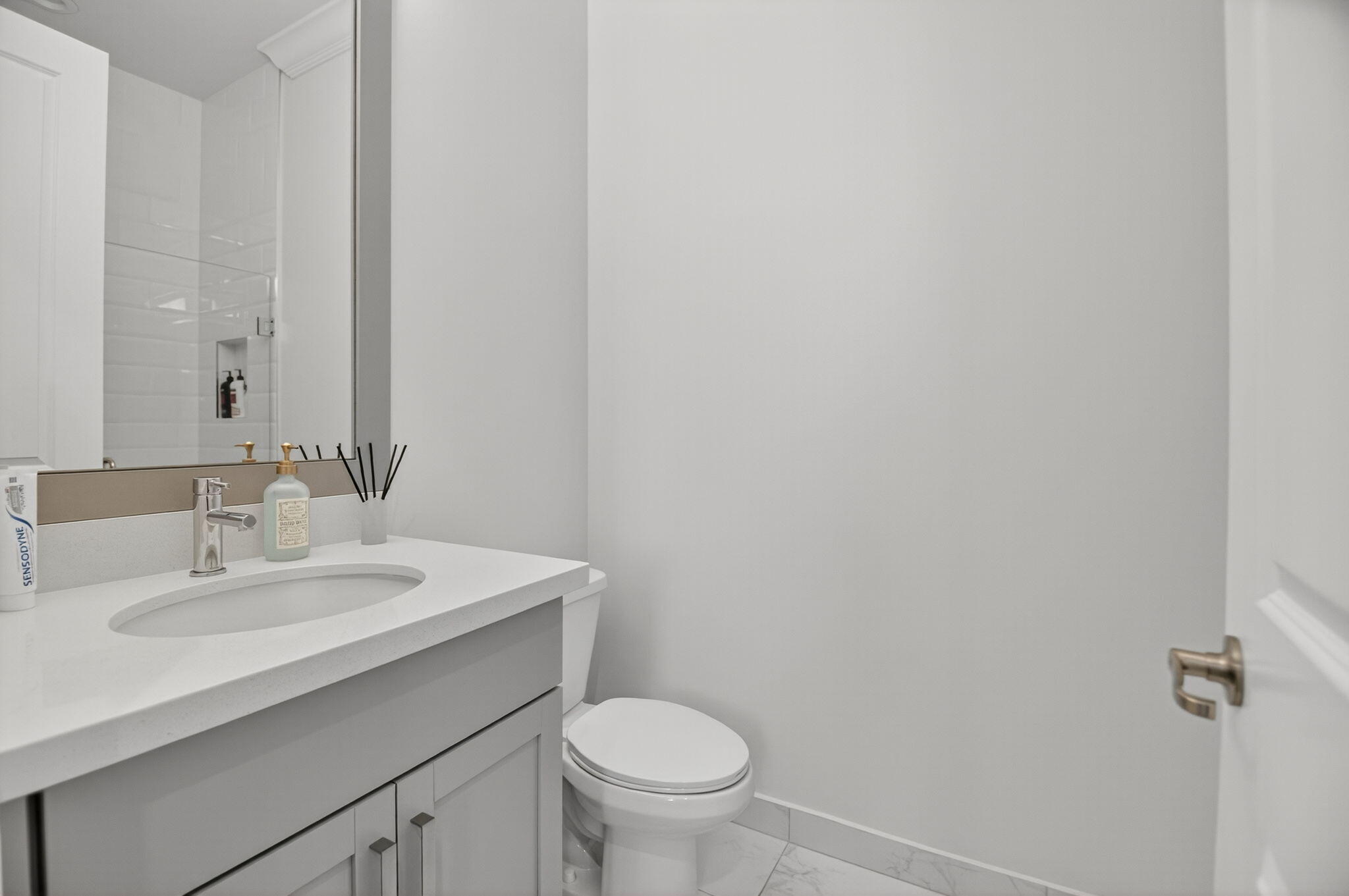 9331 Grand Prix Lane Boynton Beach, FL 33472 - Photo 35 of 96 a bathroom with a sink toilet and a mirror