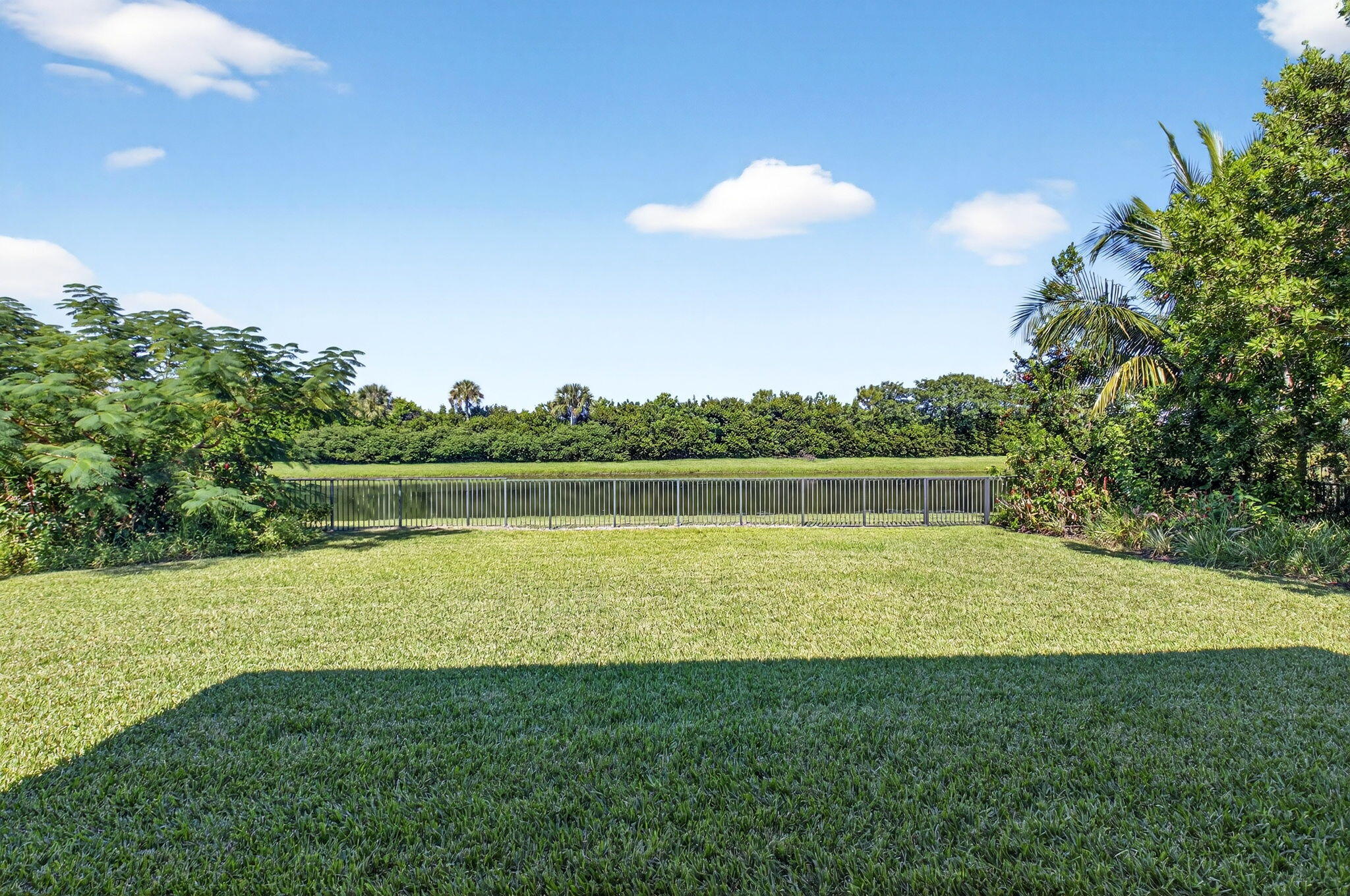9331 Grand Prix Lane Boynton Beach, FL 33472 - Photo 48 of 96 a view of a golf course with a lake