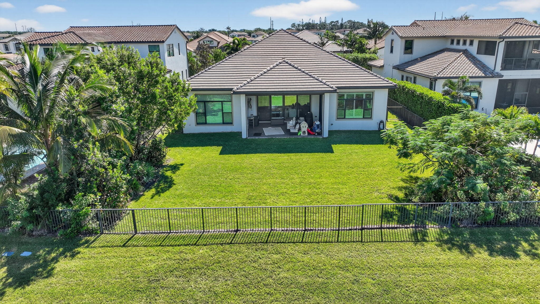 9331 Grand Prix Lane Boynton Beach, FL 33472 - Photo 66 of 96 a view of a house with a garden and sitting area