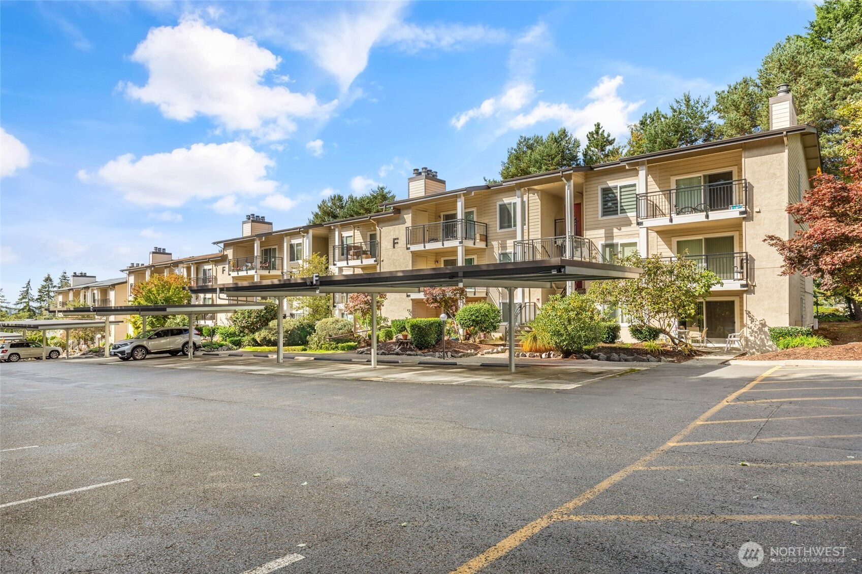 13626 Northeast 7th Street, Unit F10 Bellevue, WA 98005 - Photo 2 of 31 a view of a street with cars