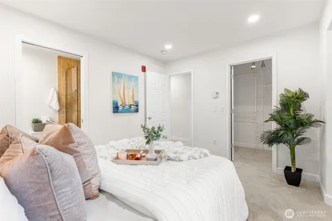 a bedroom with a bed and a potted plant