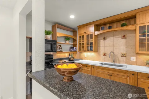 a large bathroom with sink a mirror a bathtub and shower