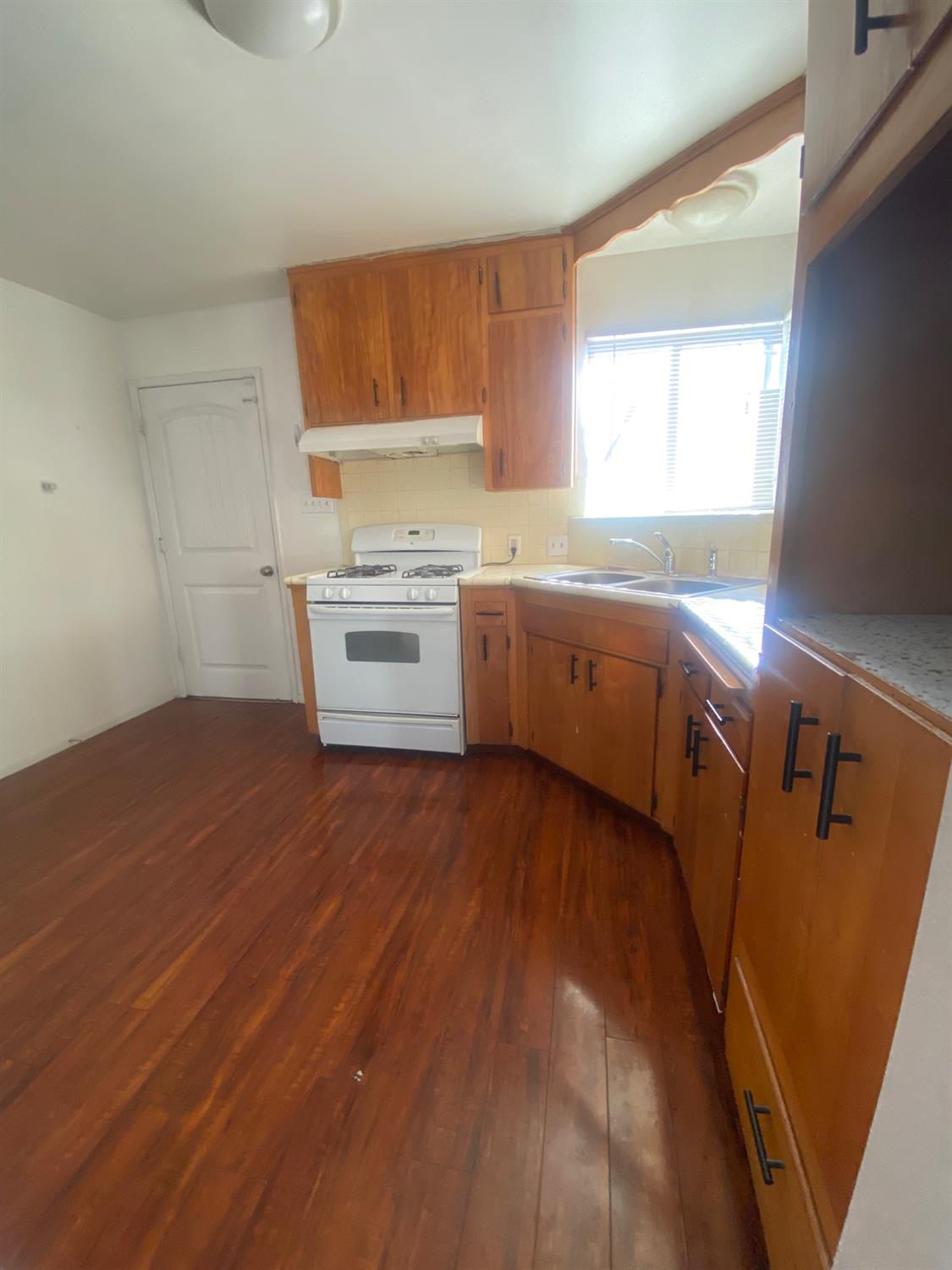 333 East Linden Avenue Reedley, CA 93654 - Photo 9 of 21 a kitchen with a cabinets and wooden floor