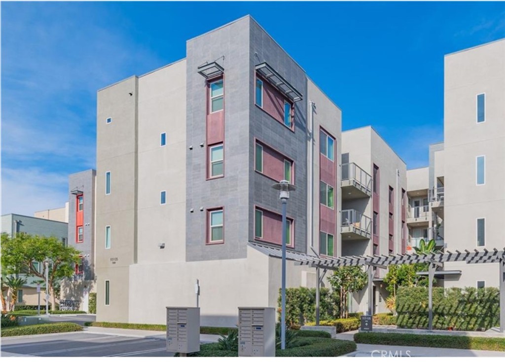 a front view of a multi story building with yard